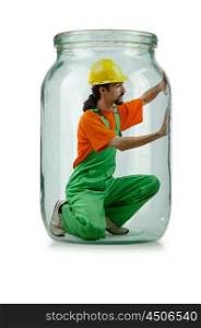 Man in coveralls imprisoned in glass jar