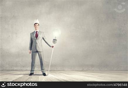 Man in crown. Young handsome businessman wearing white paper crown
