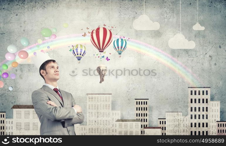 Man in crown. Young handsome businessman wearing white paper crown