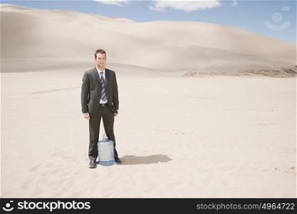 Man in desert with water bottle