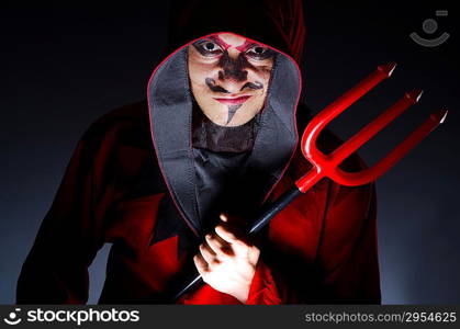 Man in devil costume in halloween concept