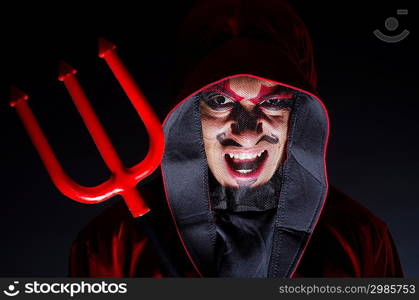 Man in devil costume in halloween concept