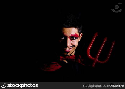 Man in devil costume in halloween concept