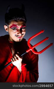 Man in devil costume in halloween concept