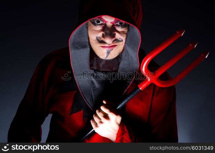 Man in devil costume in halloween concept