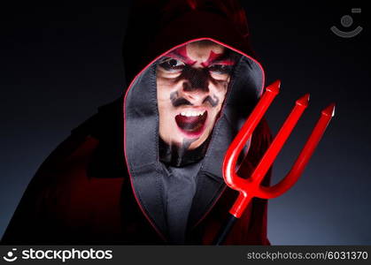 Man in devil costume in halloween concept