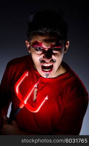 Man in devil costume in halloween concept