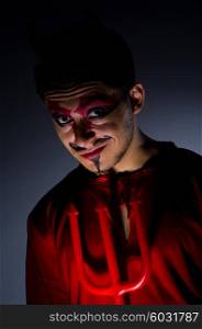 Man in devil costume in halloween concept