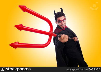 Man in devil costume in halloween concept