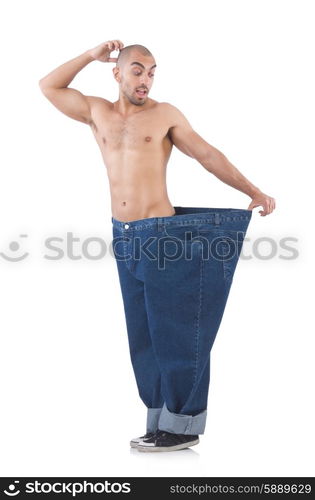 Man in dieting concept with oversized jeans