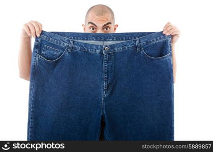 Man in dieting concept with oversized jeans