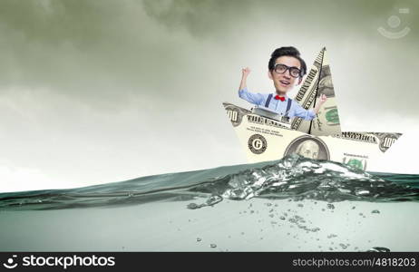 Man in dollar boat. Businessman escapes from crisis on paper boat made of dollar banknote