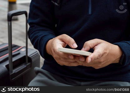 Man in downtown city street ordering taxi using smart phone app Booking taxi using application online on smart phone.