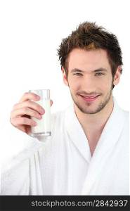 Man in dressing gown drinking glass of milk