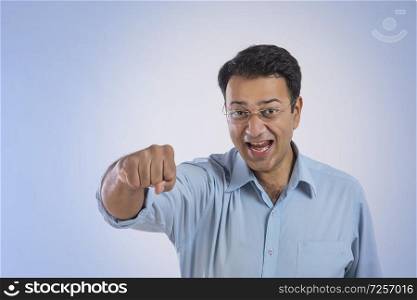 Man in eyeglasses showing his closed fist with an expression of excitement and happiness