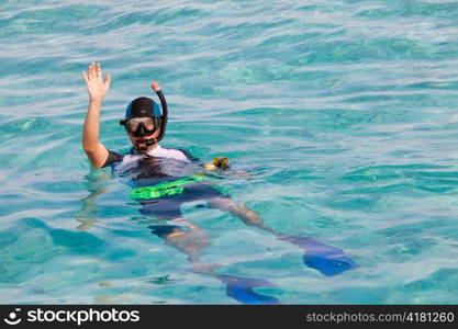 Man in flippers and mask in ocean, Maldives