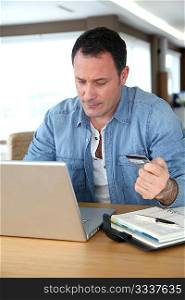 Man in front of computer doing online payment