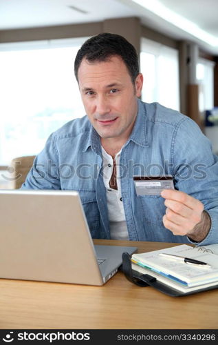 Man in front of computer doing online payment