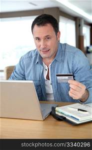 Man in front of computer doing online payment