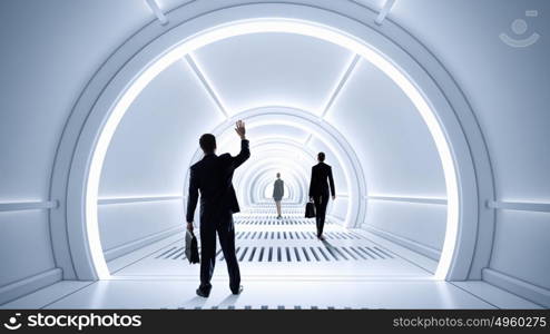 Man in futuristic interior. Businessman standing in virtual designed tunnel room