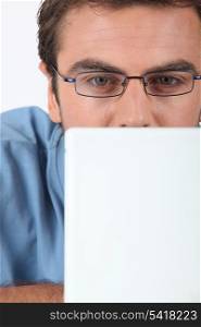 Man in glasses using laptop