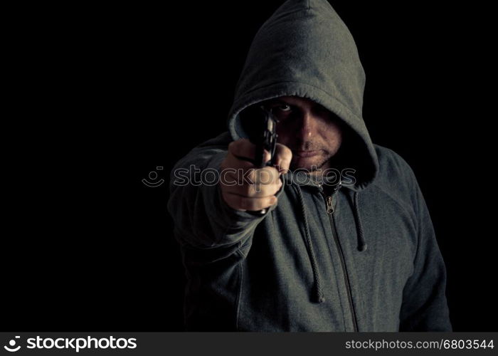 Man in green hoodie points gun