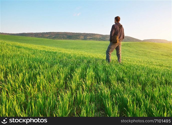 Man in green meadow. Conceptual scene.