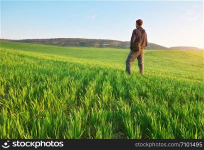 Man in green meadow. Conceptual scene.