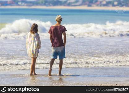 Man in Hat and a girl on a Tropical Beach.Jimbaran.Bali.Indonesia.
