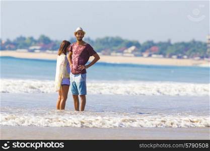 Man in Hat and a girl on a Tropical Beach.Jimbaran.Bali.Indonesia.