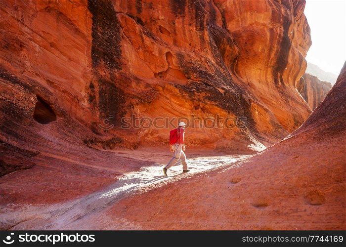 Man in hike in the slot canyon in summer mountains. Utah, USA