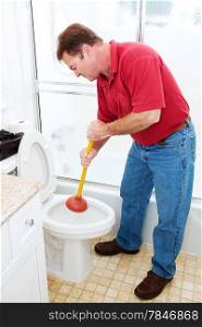 Man in his bathroom unclogging a toilet with a plunger.