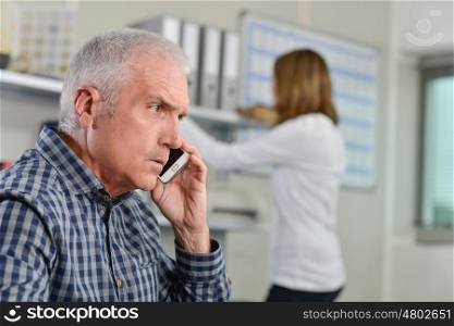 Man in his office on the phone