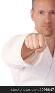 Man in karate-gi in low DoF behind his fist