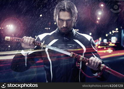 Man in leather clothing holding a sword.