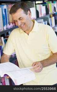 Man in library reading book (depth of field)