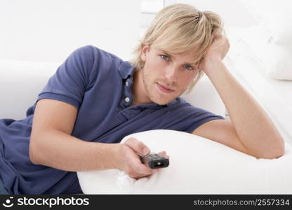 Man in living room holding remote control
