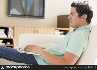 Man in living room using laptop