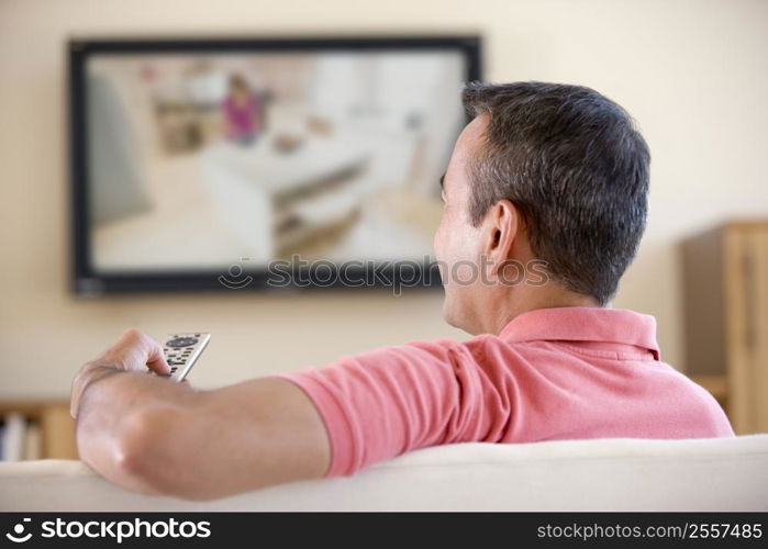 Man in living room watching television