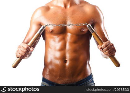 Man in martial arts concept with nunchucks