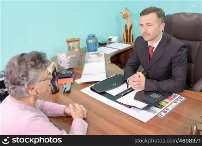 Man in meeting with elderly lady