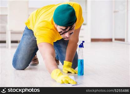Man in military style cleaning the house
