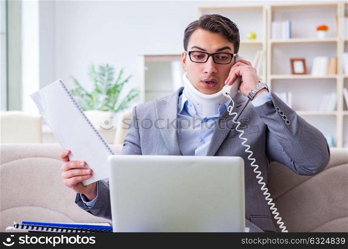 Man in neck brace cervical collar working from home teleworking