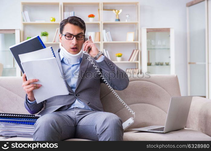 Man in neck brace cervical collar working from home teleworking