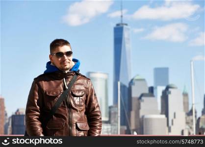 Man in New York City with Manhattan skyline at background