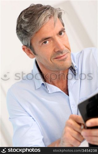Man in office using calculator