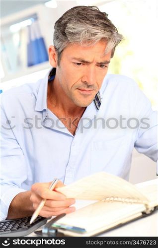 Man in office with worried look on his face
