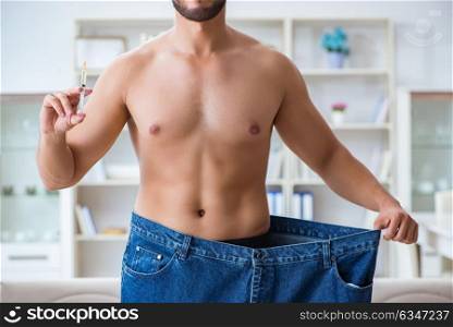 Man in oversized pants in weight loss concept