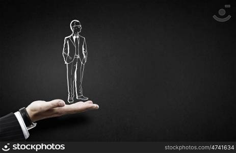 Man in palm. Human hand presenting drawn businessman in palm