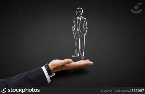 Man in palm. Human hand presenting drawn businessman in palm